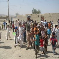 The children like to walk and hold the hands of the coalition forces